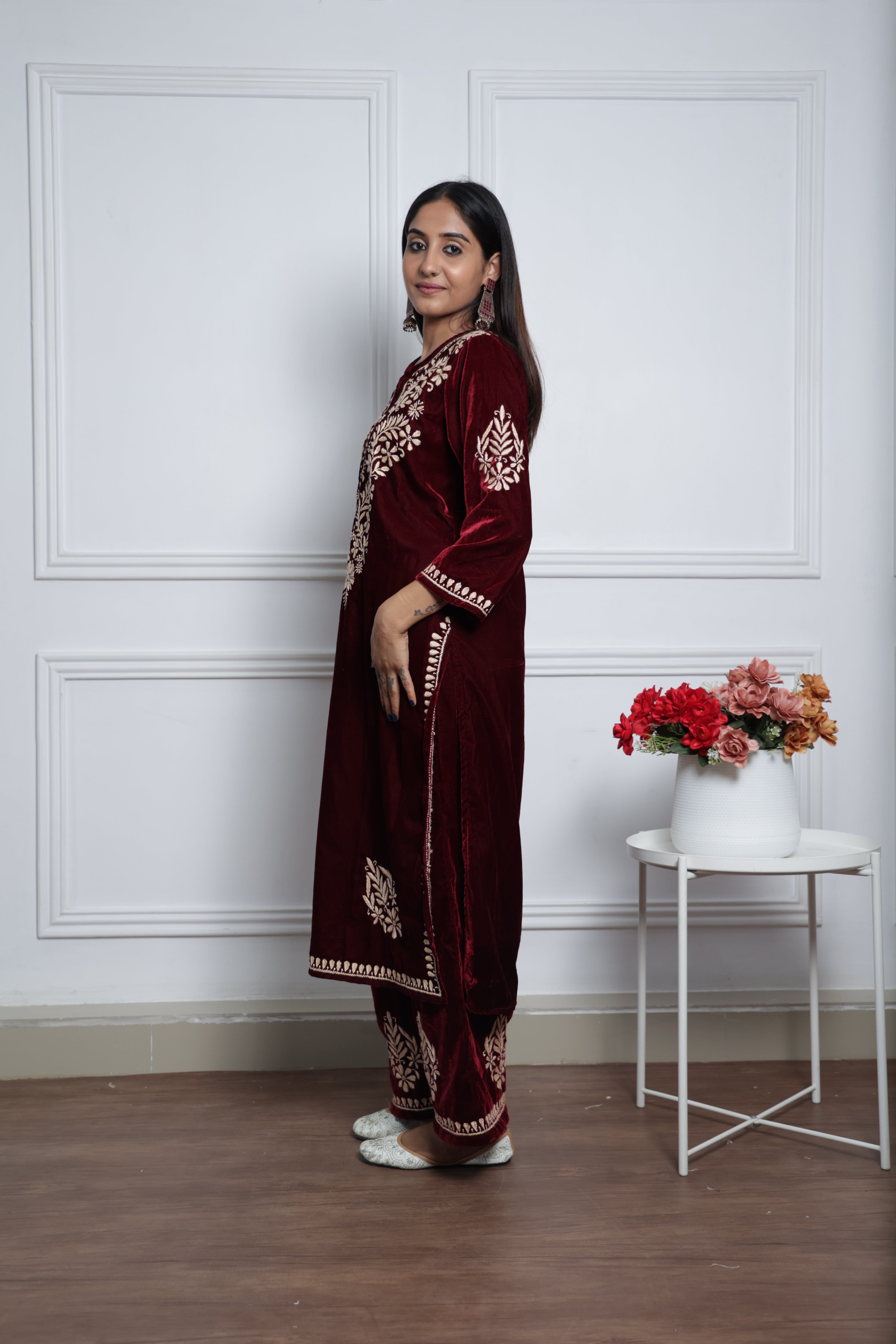 Woman wearing a maroon embroidered kurta set.