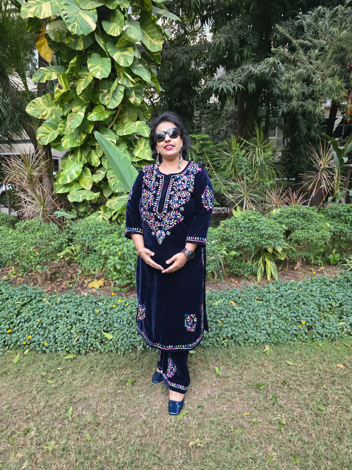 Woman in a dark blue embroidered outfit